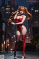 A woman in a red bodysuit is standing in the middle of a city.