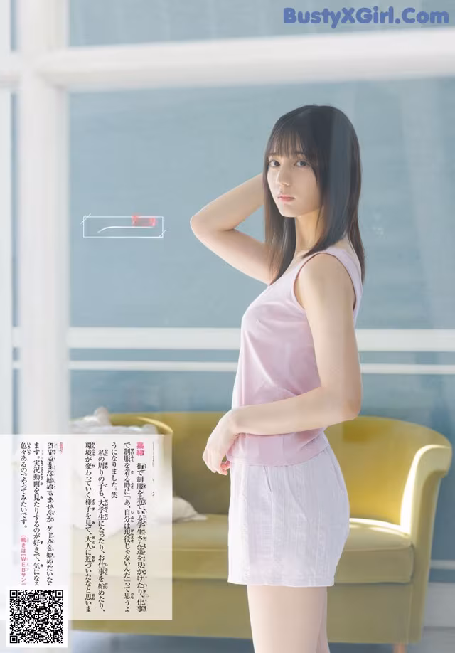 A woman in a pink top and white skirt posing for a picture.