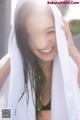 A woman with a white towel wrapped around her head.