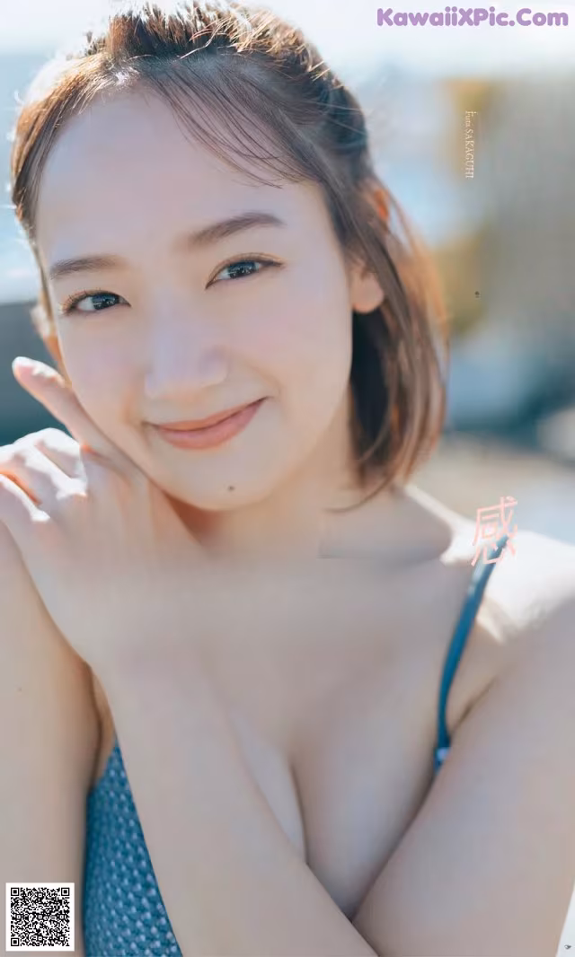 A woman in a blue bikini posing for a picture.