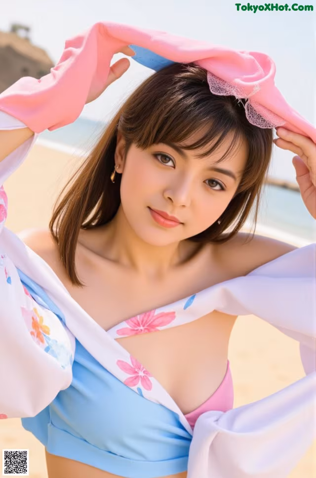A woman in a blue and pink bikini on the beach.